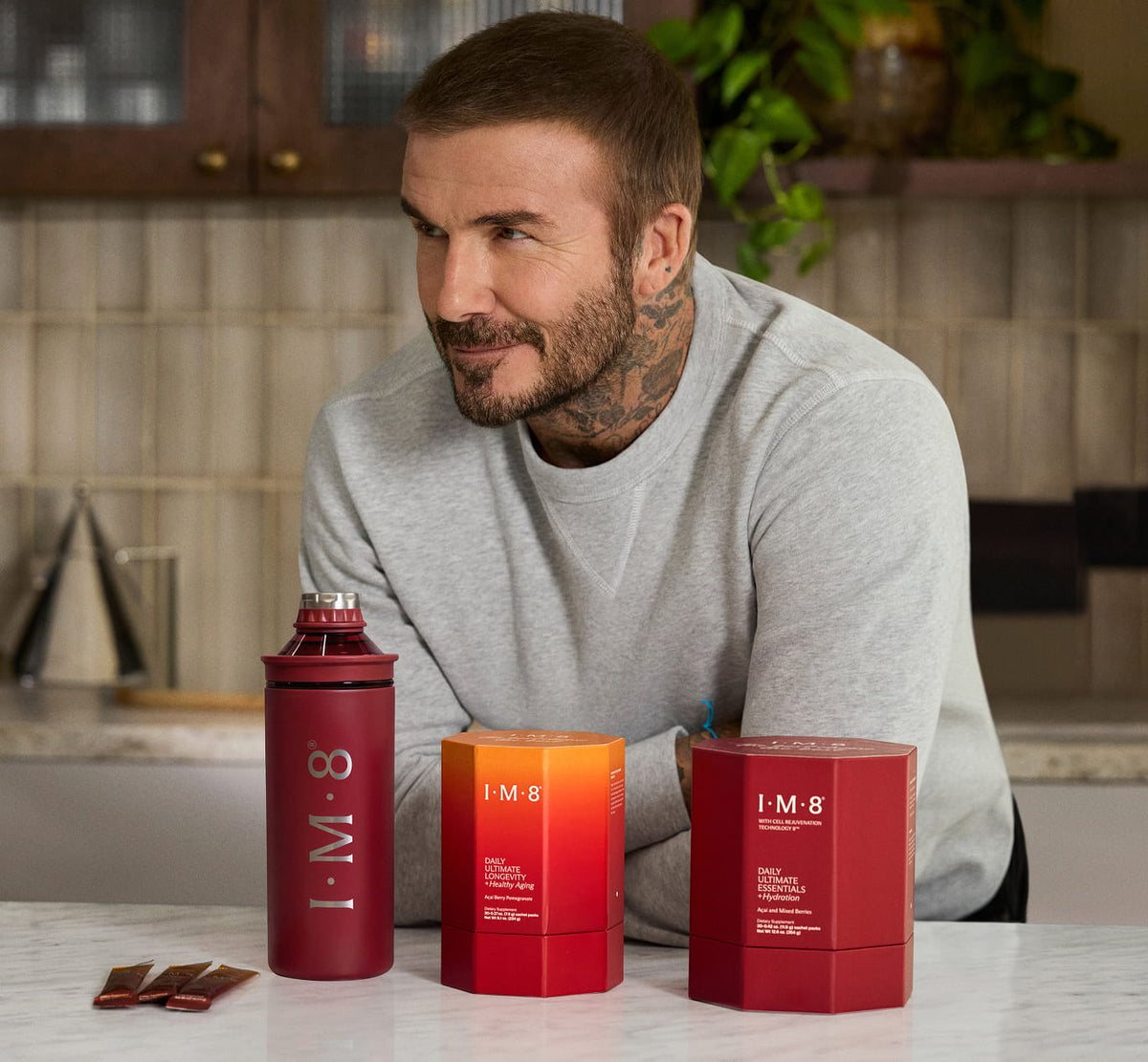 David Beckham, IM8 co-founder, with Daily Ultimate Essentials, Daily Ultimate Longevity and the signature bottle