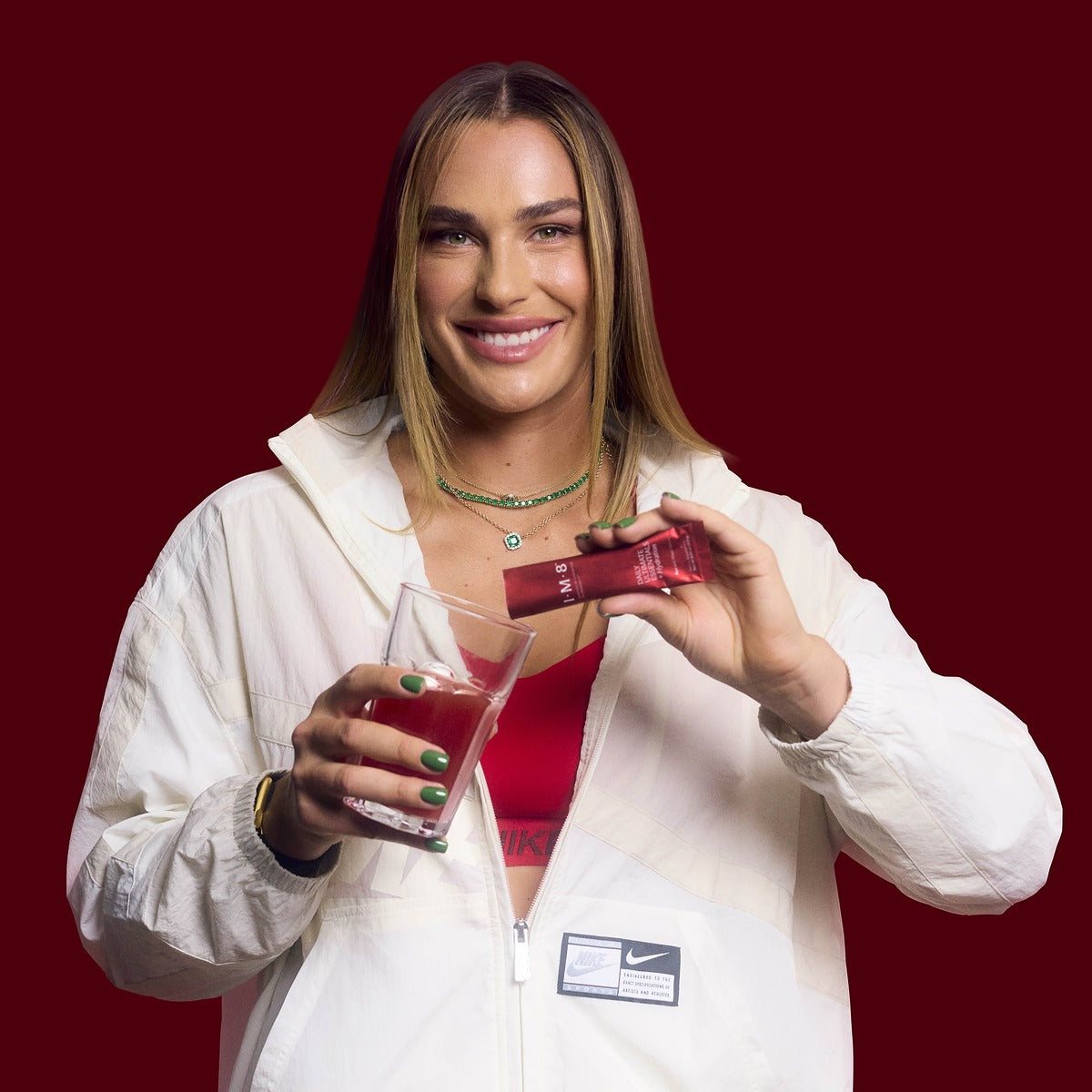Aryna Sabalenka with a Daily Ultimate Essentials sachet and a prepared glass